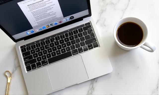 A laptop showing an e-commerce checkout page with clear terms and conditions